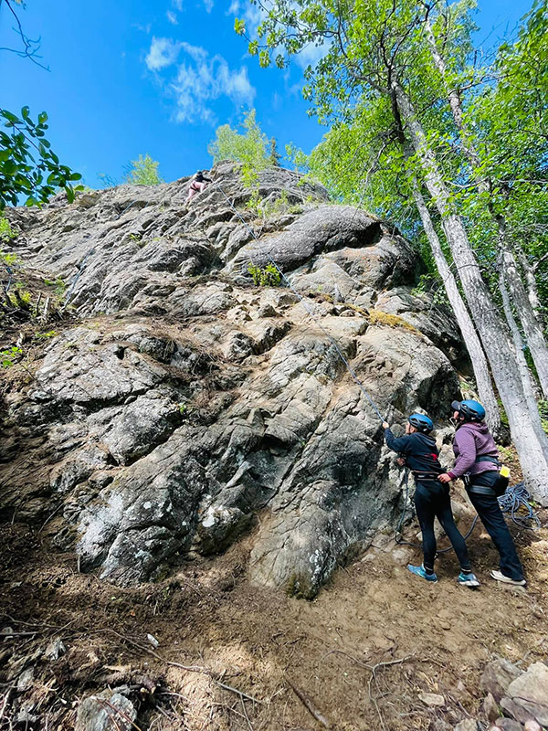 girls looking up at rocks